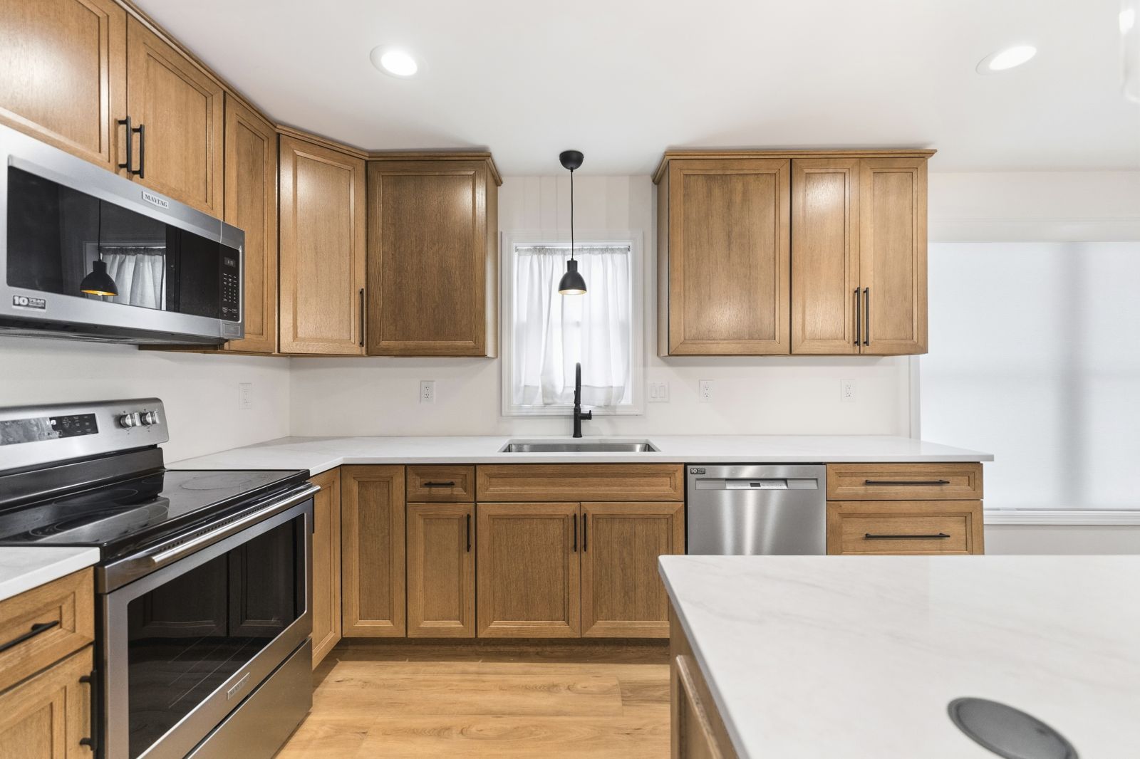 Oak cabinetry around the range and sink wall